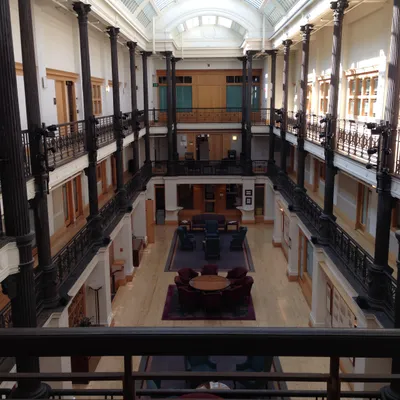 Historic library reading room with arched skylights and multi-story balconies